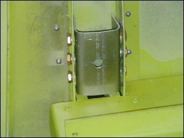 Install set belt attachment brackets in channel left and right of center spar and bolt them in place with AN3-3 bolts and inside star lock washers