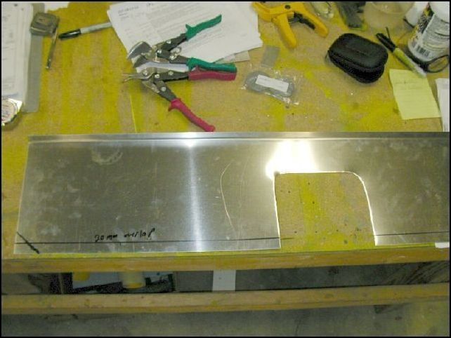 Cut out the area you just marked to clear the control cables.  Then mark 20 mm from the bottom for the overlap.