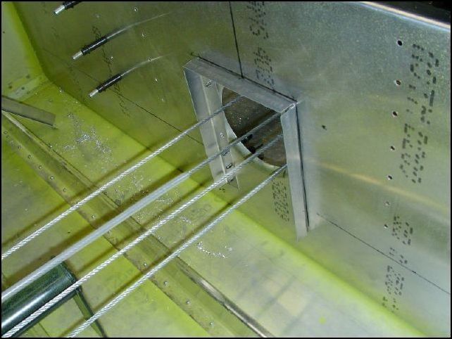 Cut standard L angles to fit around the center lightning hole of the front seat support and the main spar.  These Ls MUST be 130 mm apart so that the tunnel top will fit.