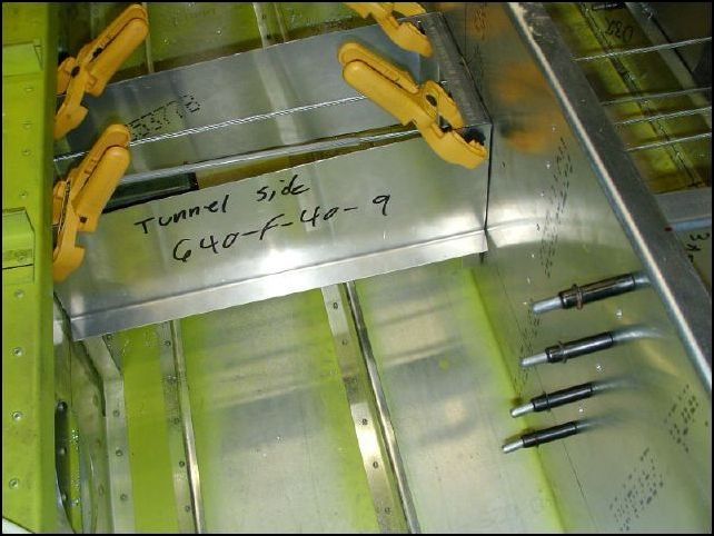 Trim the tunnel sides (640-F-40-9) to fit between the front seat support and the main spar.  Clamp them in place.  The bottom of these should be flush with the location of the rear seat floor wich is shown as 150 mm at the main spar and 140 mm at the front rear seat support from the bottom fuselage skin.