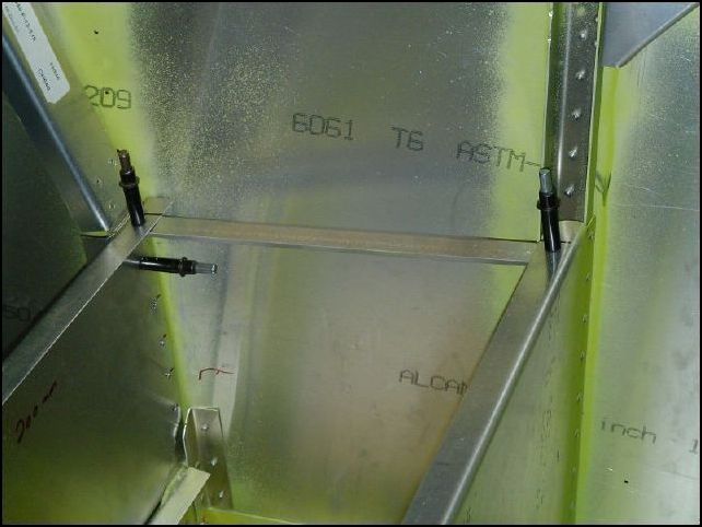 Cut two standard Ls to fit between the rear and front seat supports.  Drill and cleco them at both sides to support the seat panel.  NOTE:  the IPL says to rivet them to the side skins, however the seat panel does not reach the side skins so if you follow the IPL then these will not support anything.  Move them in toward the center so that they will support the sides of the seat panel.