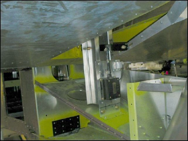 Deburr, clean, prime and rivet the electric trim assembly to the fuselage.  Connect the trim tab fork to the electric trim arm with bolt and washers as per drawings.