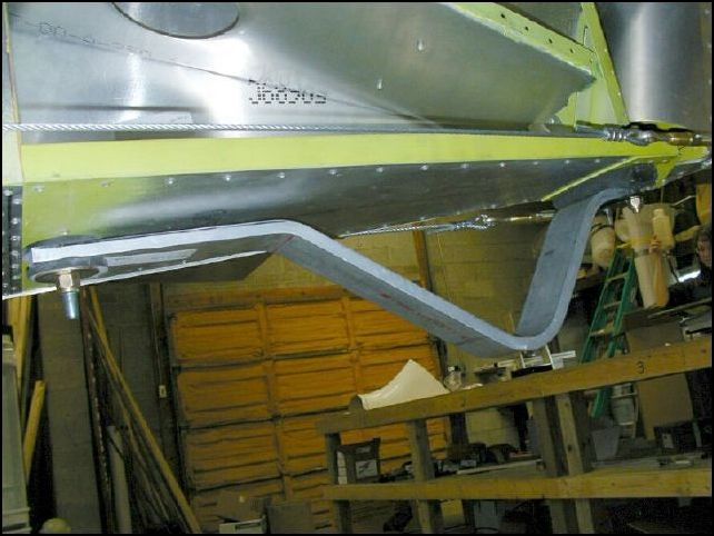 Before riveting the side skins install the tail skin.  Not much to say on this step, just drill a hole in the front of the skid for the bolt that is attached to the HT assembly.  Then use two AN3 bolts to attach the rear of the skid with the rubber hose between the skid and the lower rudder hinge.  Yes, you will have to drill out two of the AD5 rivets that the IPLs had you install before.