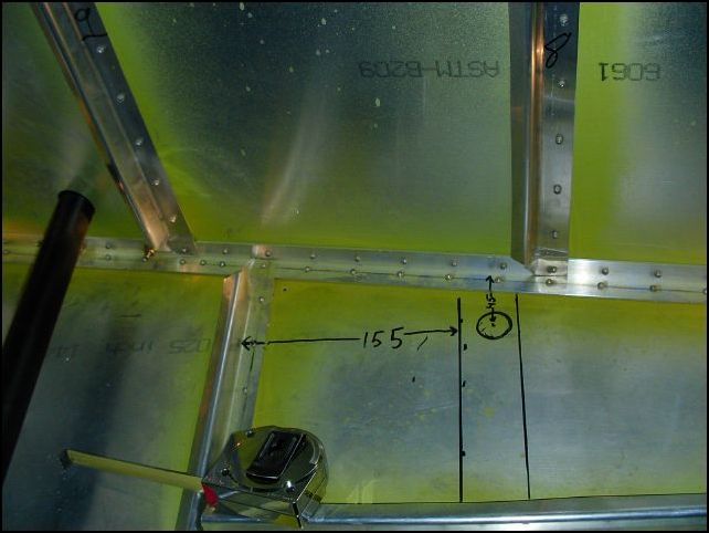 I had to drill the rivets out of my baggage area AGAIN to do this, but I really wanted these steps so here we go.  Measure 155 mm back from the front of the front access door Z.  This is the location of the front of the floor stiffener.  measure 45mm from the fuselage skin, this is the center of the 7\8