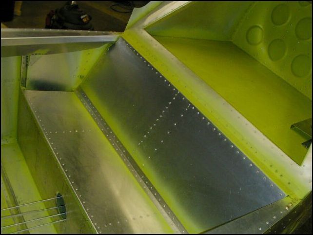 Rivet the rear seat back and the bottom rear seat back angle in place.