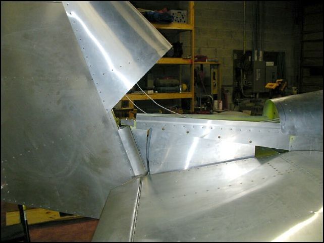 Deburr, clean, prime, and rivet the rudder gap fill and rudder stops.
