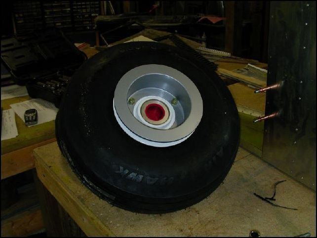 insert the three rim bolts and slide the other side of the rim in place along with the brake disk.  Now tighten all three bolts.