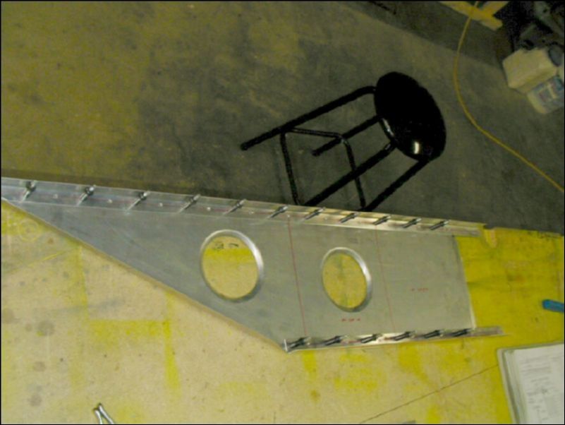 Drill and cleco the upper and lower spar cap angles to the wing extension.