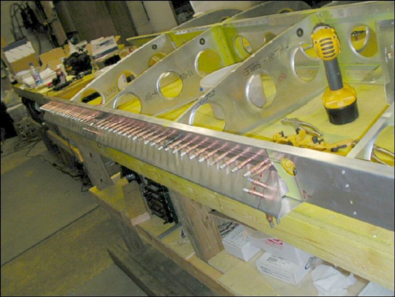 Deburr, clean, and prime front and rear channel.  Rivet front and rear channel then drill and cleco aileron support channel and gussets to rear channel.