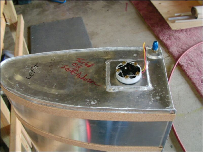 Install fuel sender, fuel fitting, and cork strips to fuel tank.  Safety wire the fuel sender bolts.
