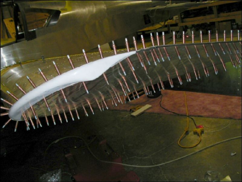 Cut wing tip skins, install the angles for the bottom tip skin, and then drill and cleco the fiberglass tip and bottom tip skin to the wing.