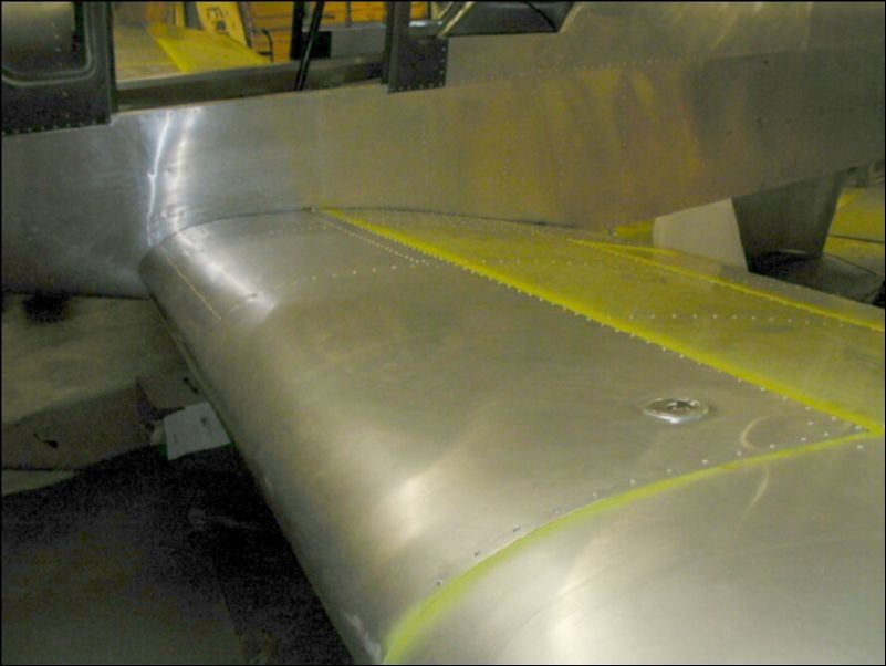 Rivet skin over fuel tank 