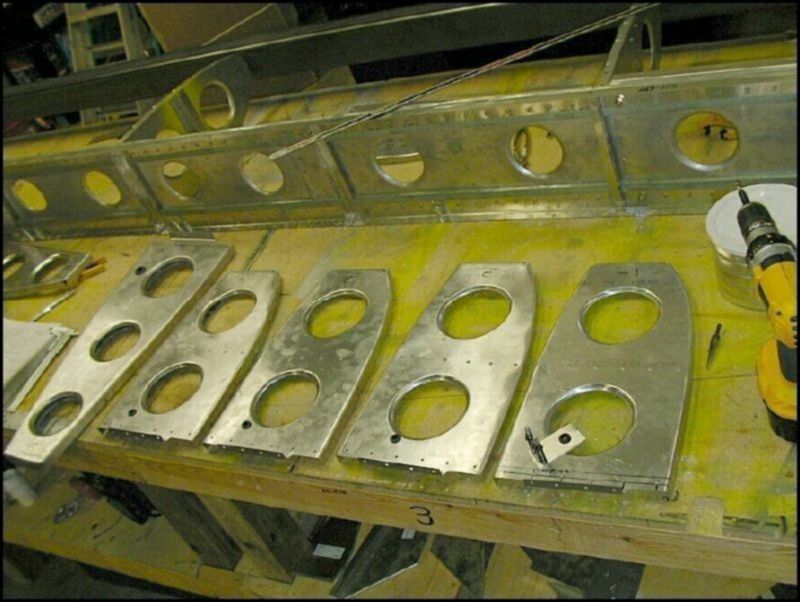 Drill fuel line holes in nose ribs 1 - 5.  Install grommets in the holes for ribs 1 - 4.  Note:  you need to make a stand off bracket for rib 1 since the hole would be in the middle of the lightening hole.  This image only shows ribs 1 - 4, the first rib to the left of the image is a rear rib with the hole for the wires drilled.