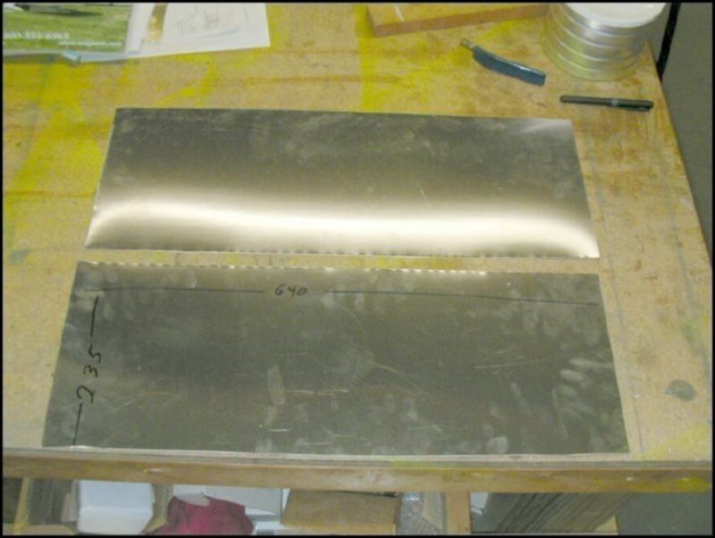 This is NOT part of the original design.  I stole this idea from Brian Walker who has been sending me photos of his wings as he builds them.  This is a GREAT idea!  The area for the fuel tank has sharp Ls behind the tank which could eventually rub a hole in the fuel tank.  So to correct this I cut a sheet of .025 aluminum 235 mm by 640 mm.
