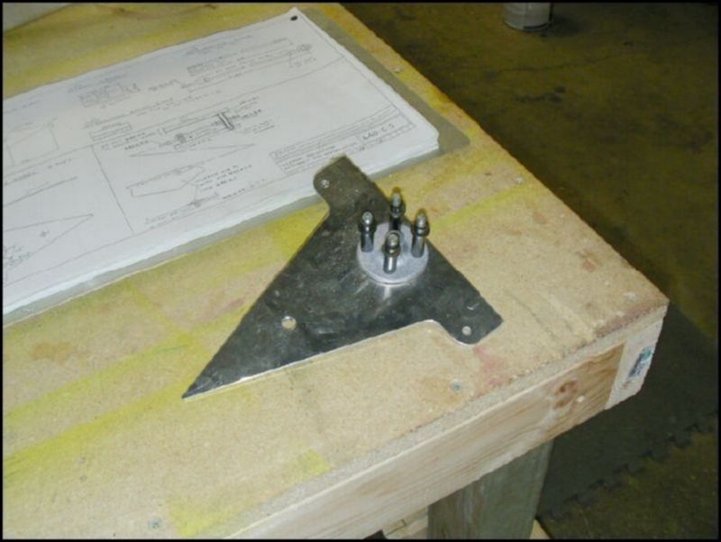 Drill 1/4 inch hole in bellcrank.  Install bellcrank bushing through hole and slide bellcrank spools on to bushing.  Drill and cleco the bellcrank spools to the bellcrank.