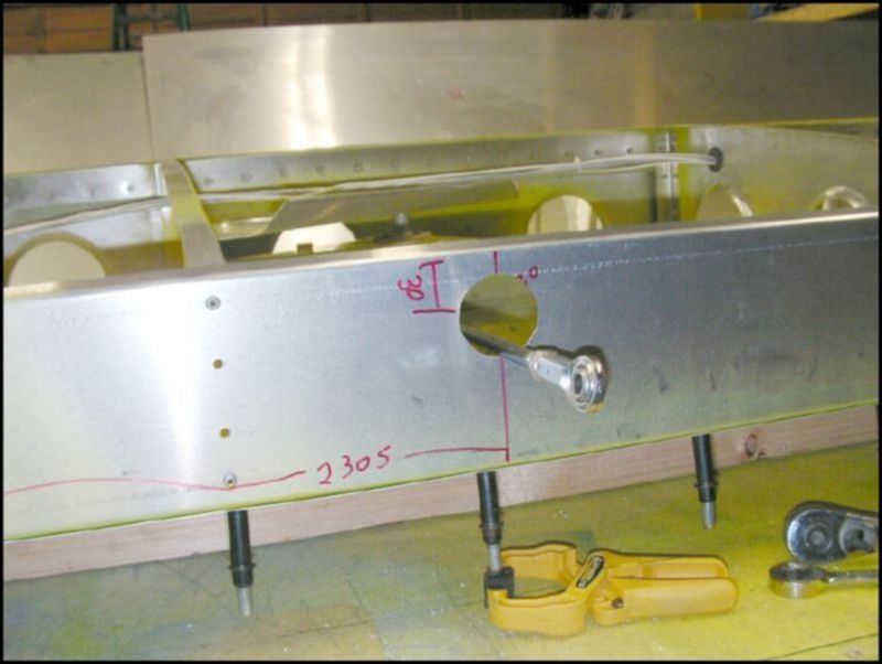Measure 2305 mm from the bottom of the rear wing attachment and 30 mm from the top of the wing.  Drill a 1.5 inch hole for the alieron rod.