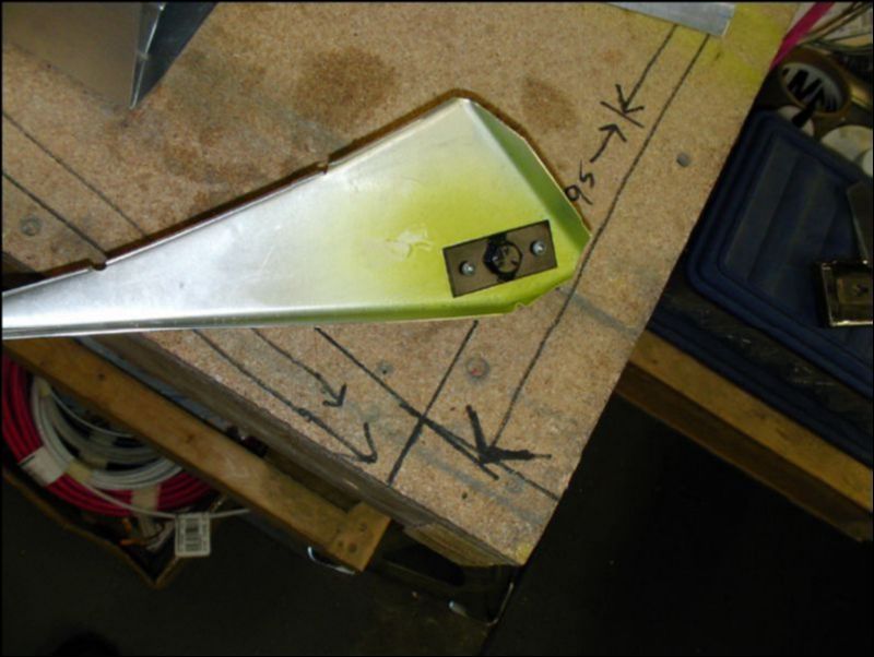 Deburr, clean, prime, and rivet the control rod bolt to the number one rib of the aileron.