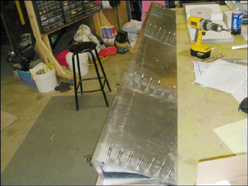 Position, drill, and coleco the four aileron ribs inside the aileron skin.