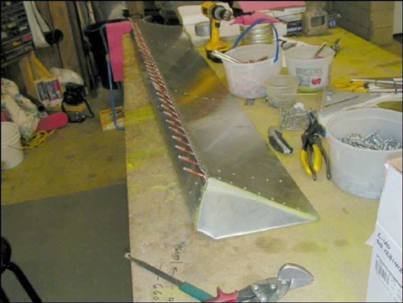 Rivet the aileron and then drill and cleco the aileron hinge.  When I build the second aileron I will drill the hinge before I rivet the rest of the aileron since it will be easier to deburr this area before riviting the rest.