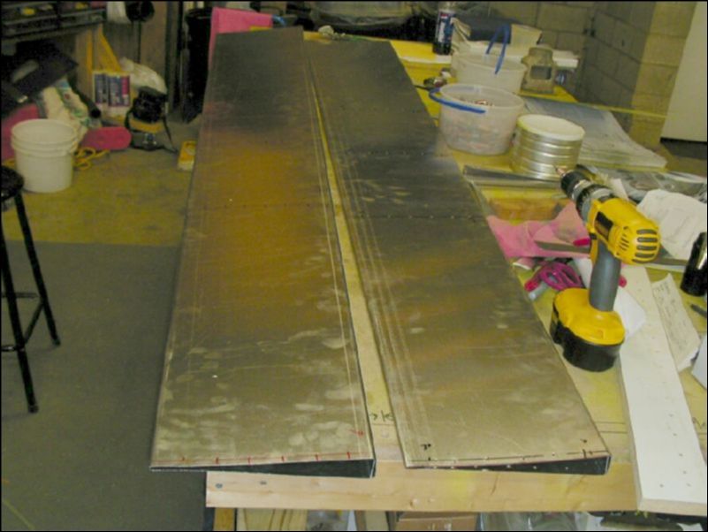 Cut flap skins as per drawings to proper length.  Mark rib rivet hole locations and pre-drill skin with #40 drill bit.