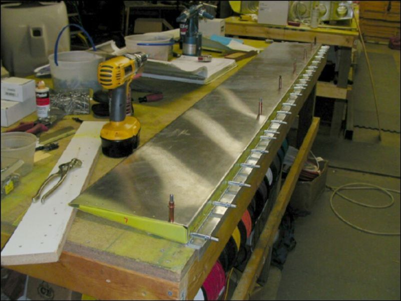 Position, drill, and cleco the flap hinge to the flap.  