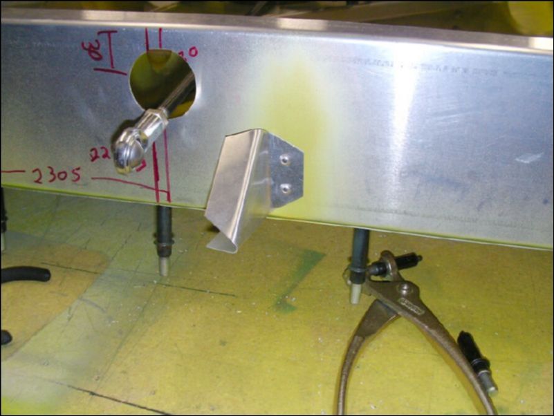 Deburr, clean, prime, and rivet the aileron support gussets.