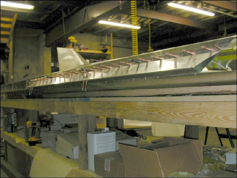 Position the aileron support channel so that the bottom edge is between the bottom skin and rear channel.  Drill and cleco.