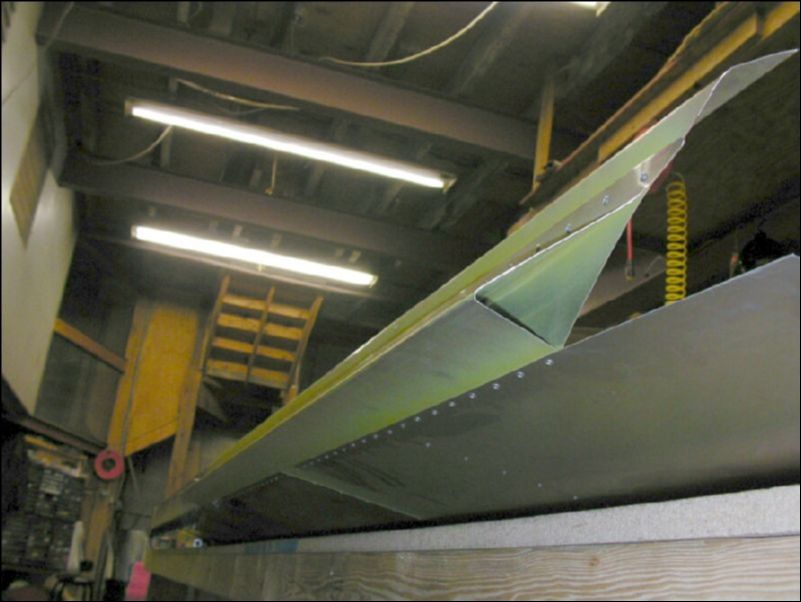 Deburr, clean, prime, and rivet the aileron support channel to the rear channel.