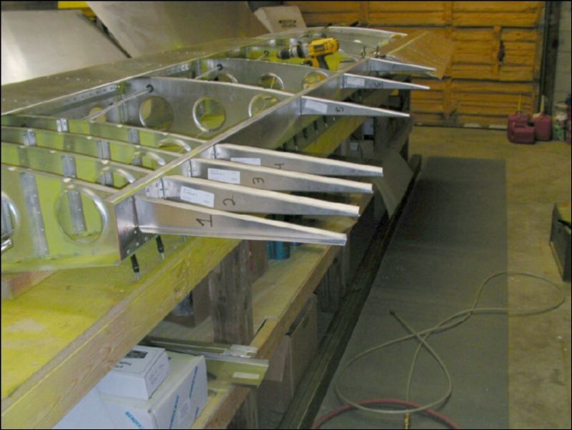 Drill and cleco the trailing edge riblets to the rear channel.  The top of each riblet is flush with the top of the rear channel.