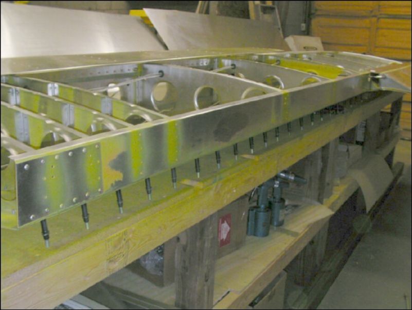 Deburr, clean, and prime rear channel.