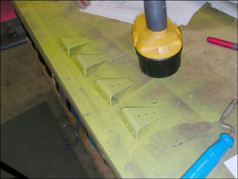 Deburr, clean, and prime gussets and riblets.