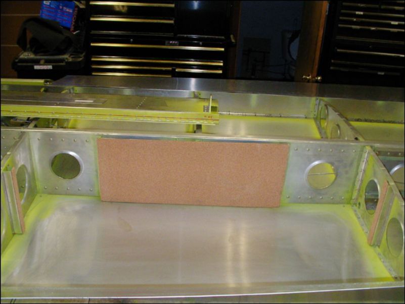 Install cork in wing to protect fuel tank