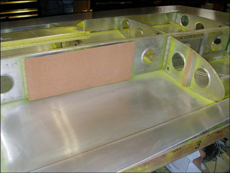 Install cork in wing to protect fuel tank