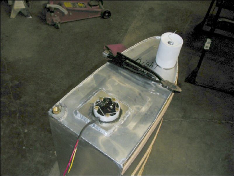 Install fuel level sender in fuel tank and safety wire bolts.