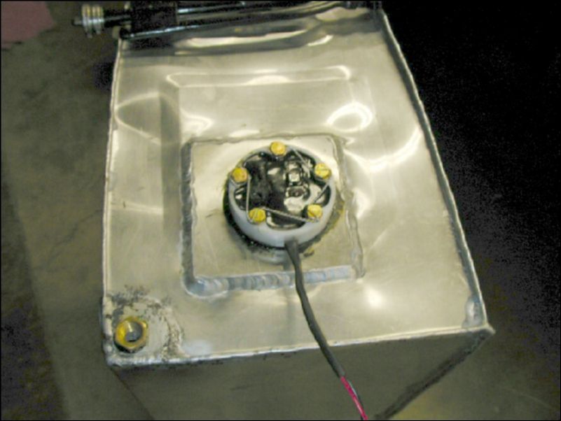 Install fuel level sender in fuel tank and safety wire bolts.