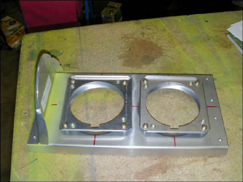 Install the light bulb backing plates to the landing light assembly.  This image does not show this well, but the backing plates are held on with four scres with springs under each screw for adjustment.