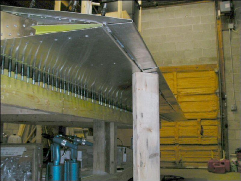 Drill and cleco the flap hinge to the rear channel between the skin and the channel.