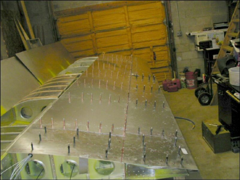 Drill and cleco the rest of the top rear skins but do not drill at the spar yet since the front skin will overlap that area.