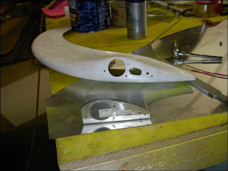 Drill holes in fiberglass wing tip for strobe light assembly.