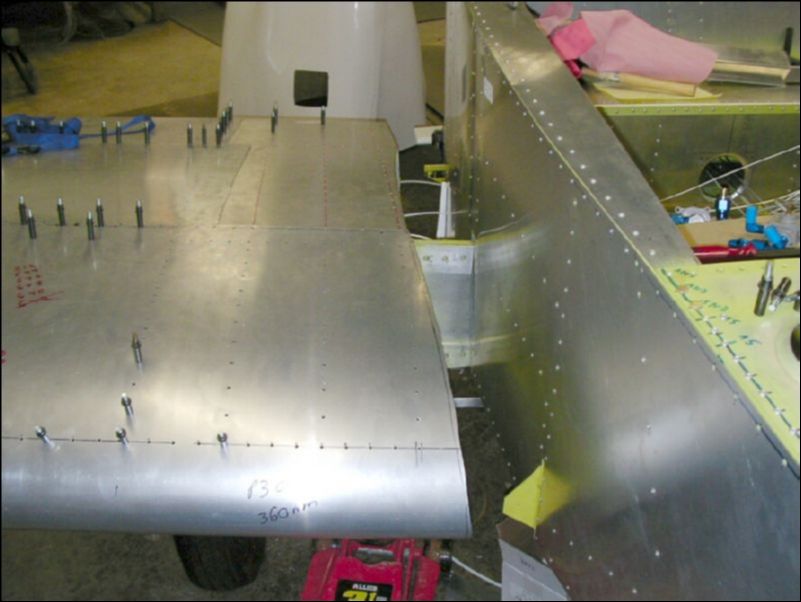 Trim the right wing skin to fit the shape of the fuselage.  I still have to tirm a bit more, but I need to get a helper to slide the wing in position before I can do much more.