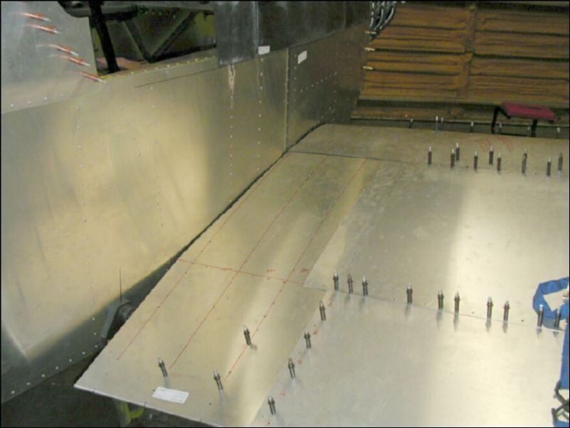 Finish trimming the right wing skin to fit the shape of the fuselage and to give access to the front and rear wing attachment areas.