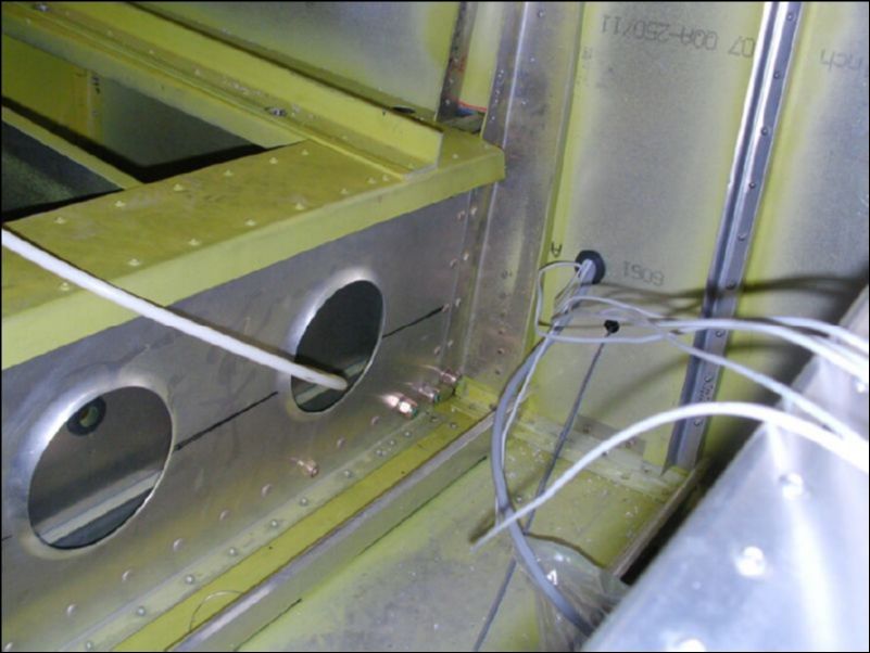 Slide wing spar inside fuselage center spar and bolt to aircraft with 6 AN6-22 bolts.  You can only see the three bottom bolts in the picture but there are three on the top also.