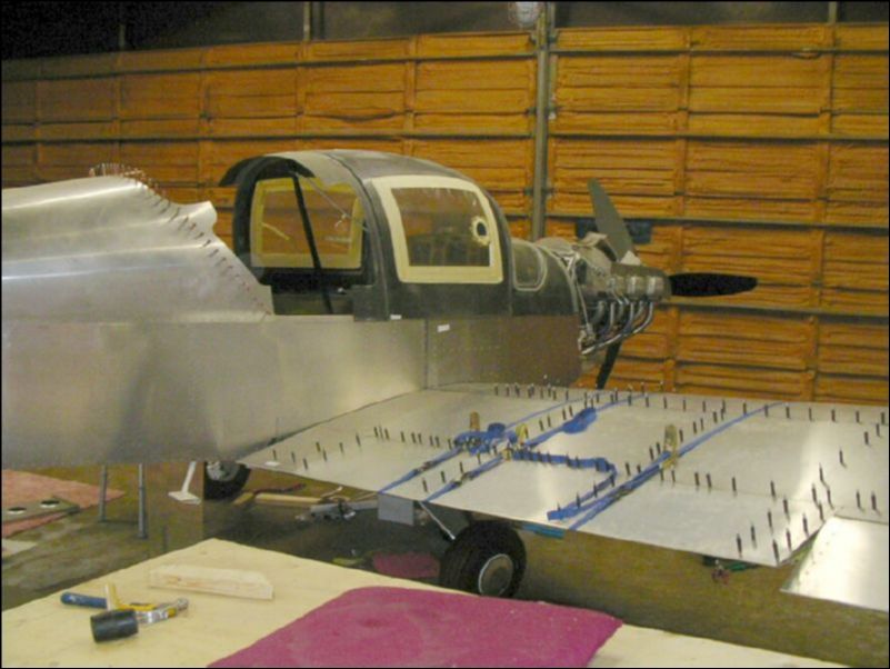 Right wing is finally bolted to the aircraft, now I can finish the top wing skins, install the fuel line, cut the access panel hole and petcock hole.