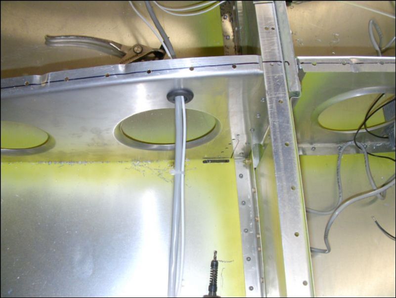 Cut slot in bottom of wing skin beside rib 9 for tiedown