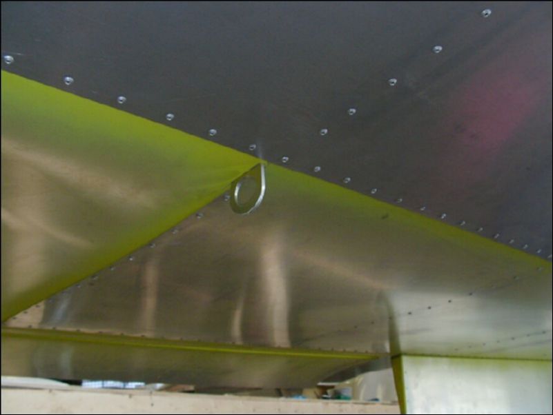 Insert tiedown in slot in bottom of wing