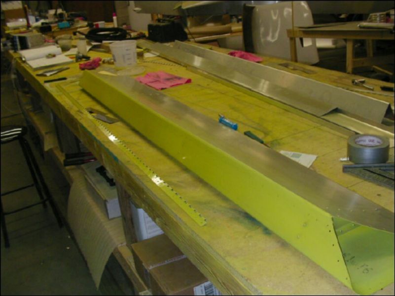 Deburr, clean, and prime aileron hinge.